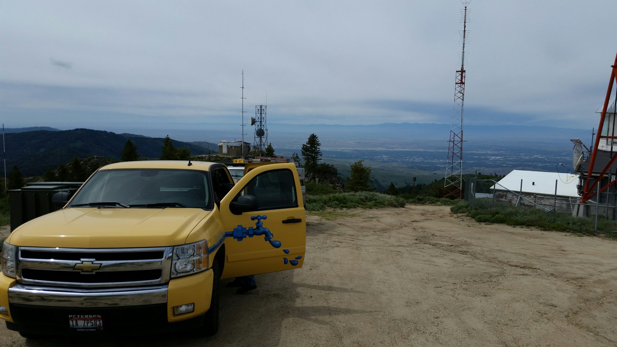 Drake’s yellow service truck at an Idaho mountain worksite